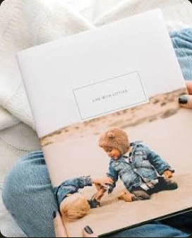 An open photo book resting on a reader's lap