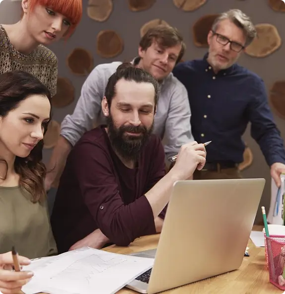 The creative team collaborating around a laptop